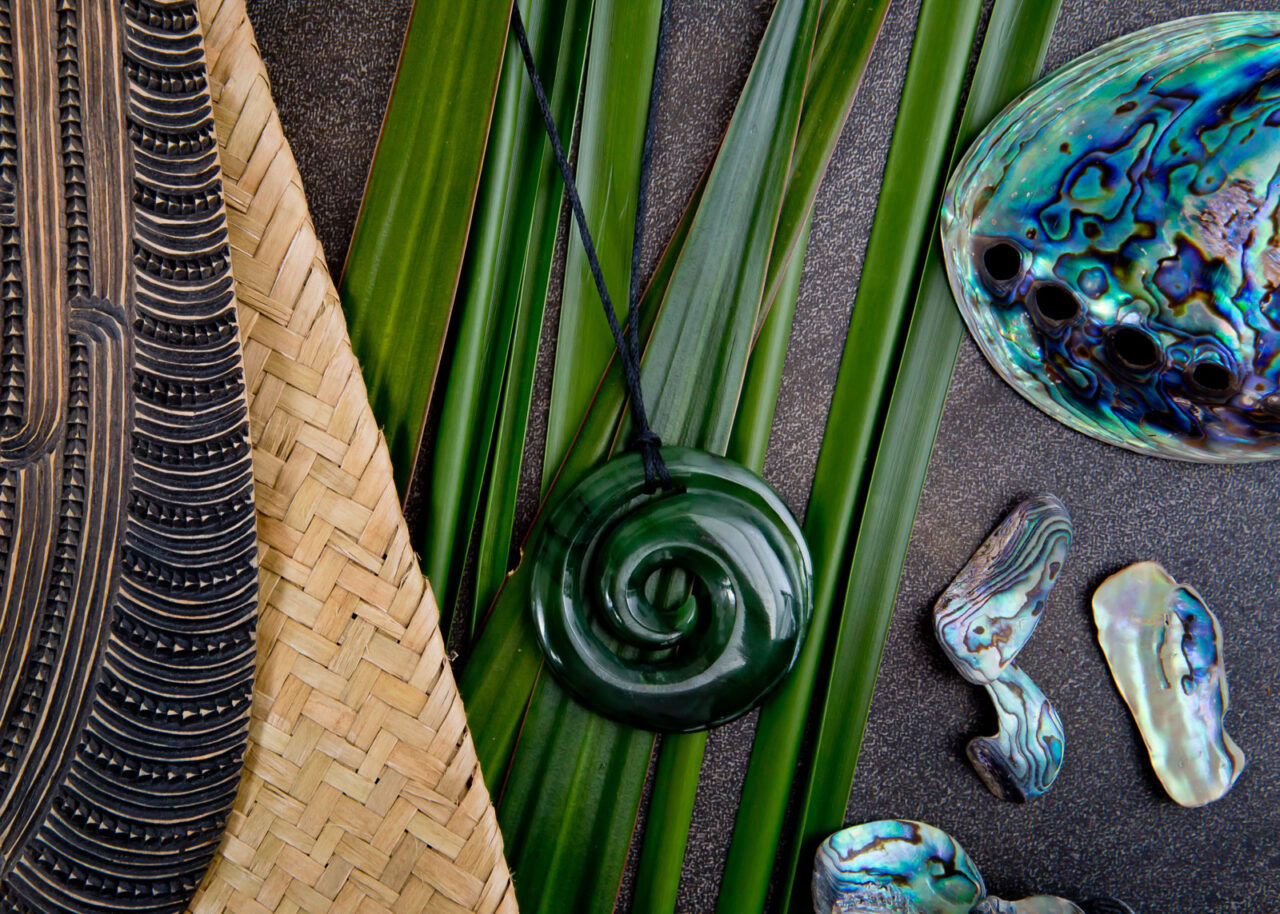 new-zealand-jade-jewelry-1280x914-1 Jade jewelry and paua shells on gray stone background
